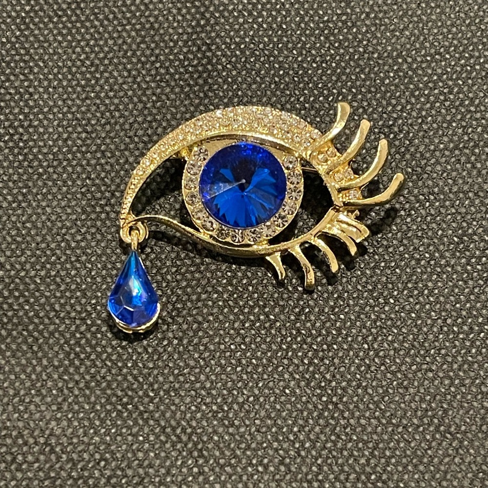Elegant Gold and Blue Eye Brooch